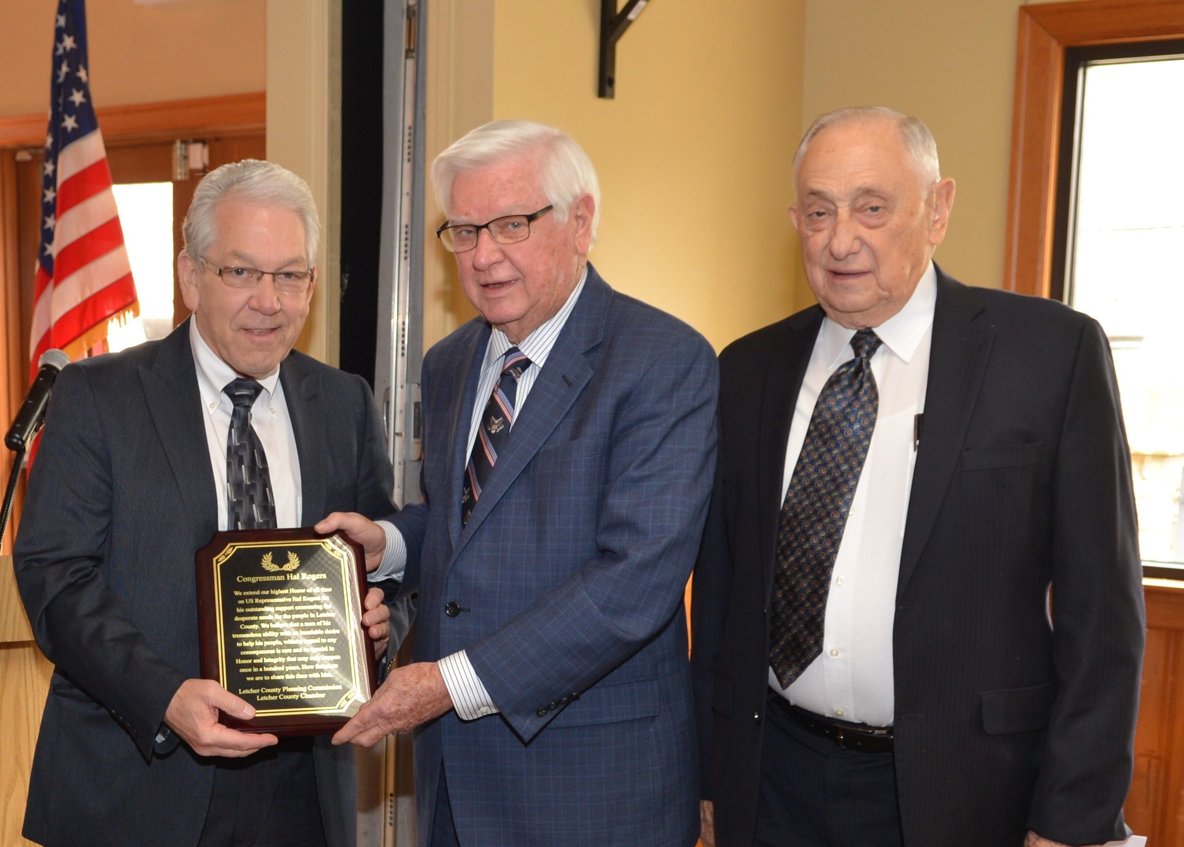 Rep. Hal Rogers (center) receives a plaque as Elwood Cornett (right) stands alongside.