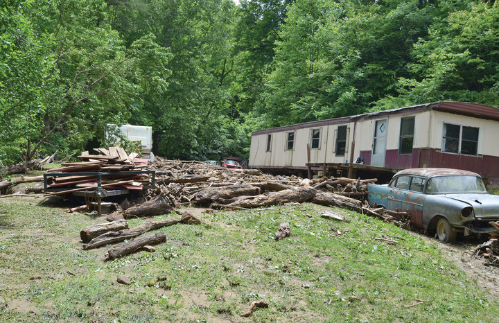 Many of the rocks and logs that flooded down the mountain were caught by the trailer just uphill from the Thacker’s home.
