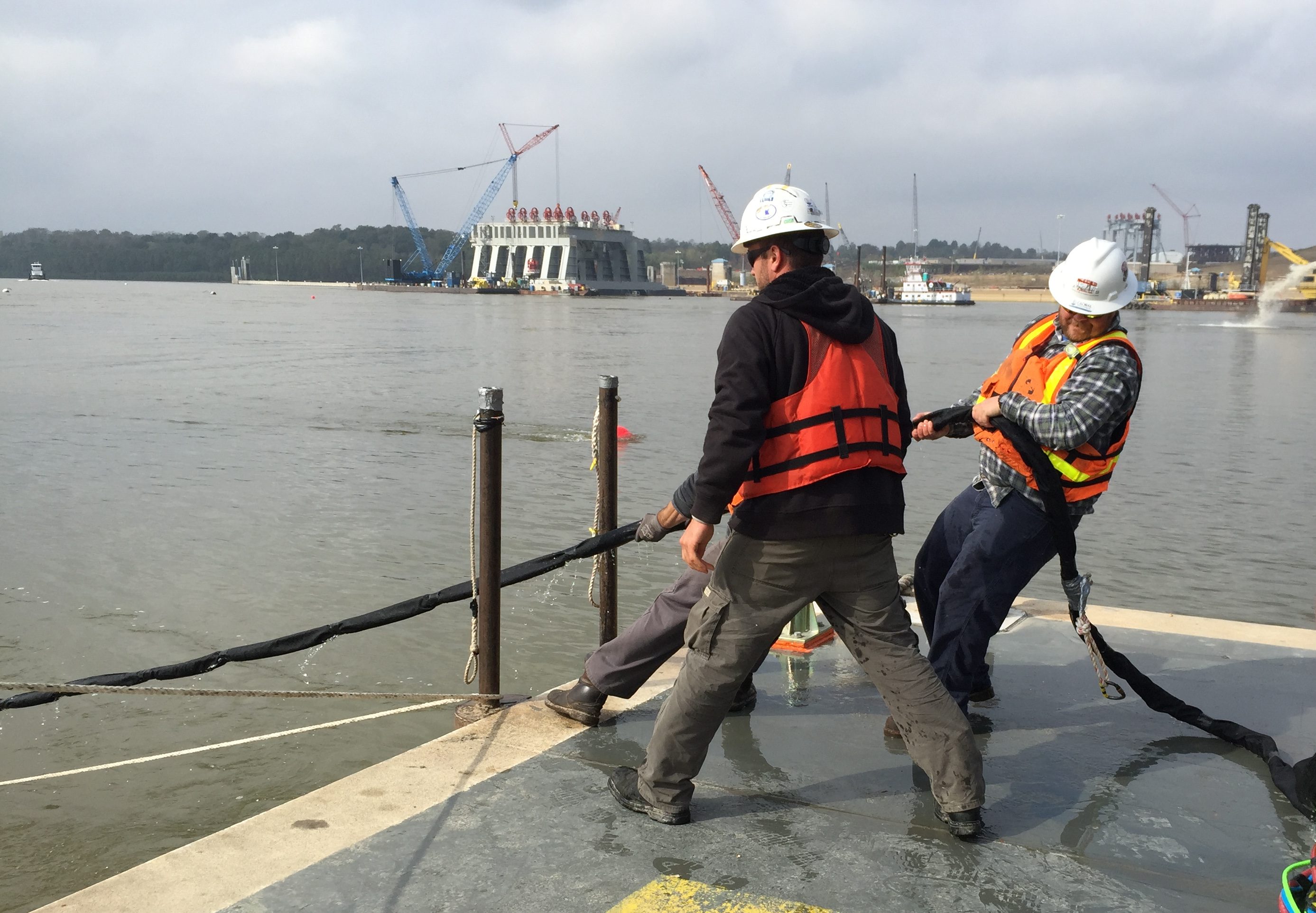 A support crew pulls a diver to the surface by the "umbilical" line at the Olmsted construction site.