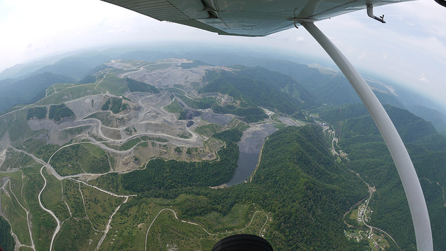 Aerial view of mountaintop removal in West Virginia. The "lake" in center is a coal sludge waste impoundment.