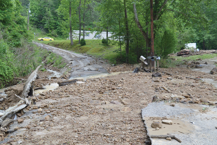 The deluge of mud and debris wiped out several portions of road, leaving families trapped.