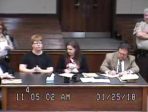 Gabe Parker (left) with defense attorneys on January 25 CREDIT SCREENSHOT FROM COURT VIDEO