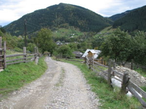 A road in rural Ukraine with mountains in the background.